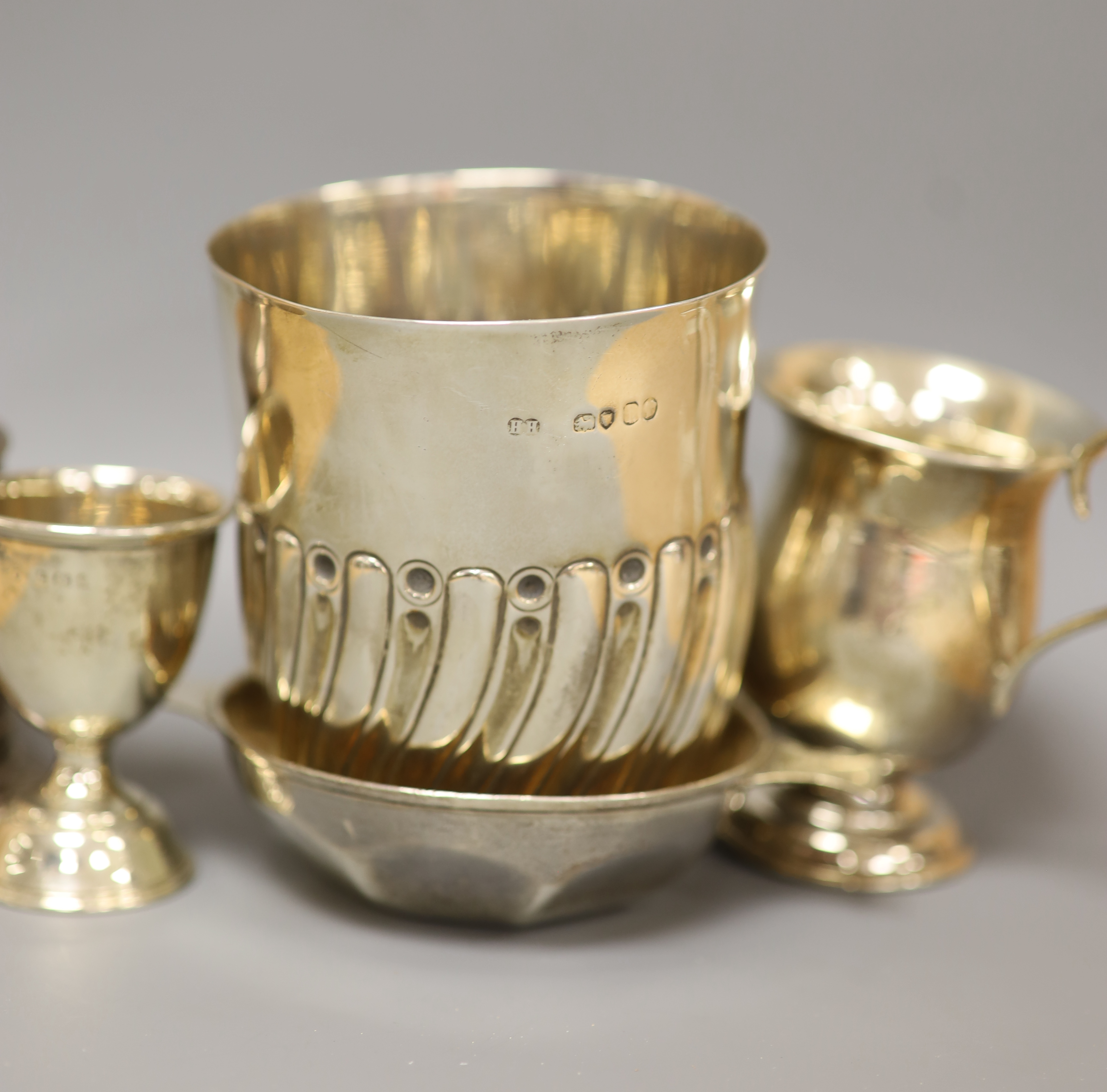 A Victorian silver half-fluted cylindrical vase, a small pedestal cup, a quaich, a Prince of Wales caddy spoon and other silver items